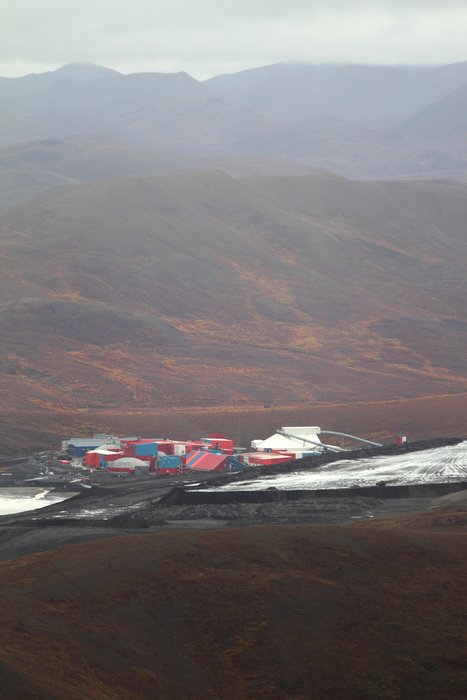 Facilities situated between the tailings pond (at right) and the mine (not visible.)  Waste rock piles are in the foreground.