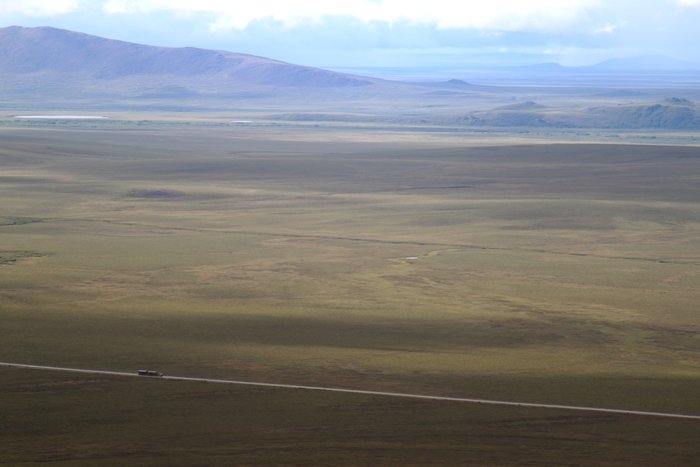 A truck full of zinc concentrate cruises down the Red Dog road.