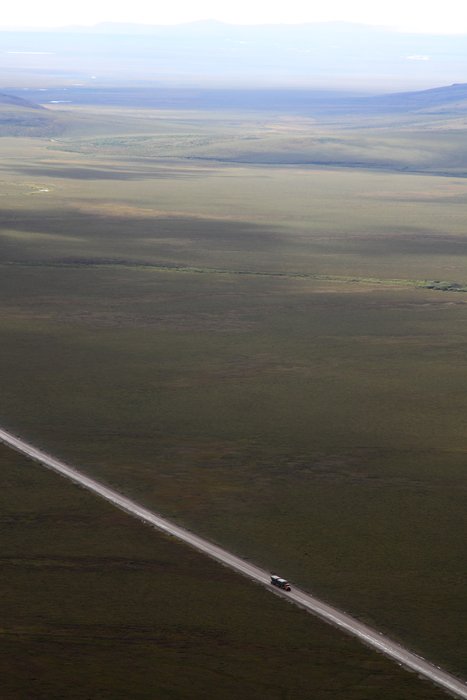 A truck full of zinc concentrate cruises down the Red Dog road.