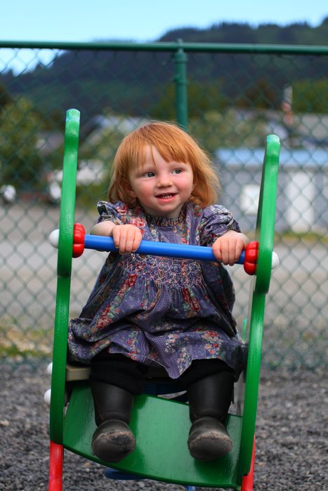 Lituya rides the seahorse at Lollipop Park, wearing a dress made by great-grandmom, for mom, 30+ years ago.