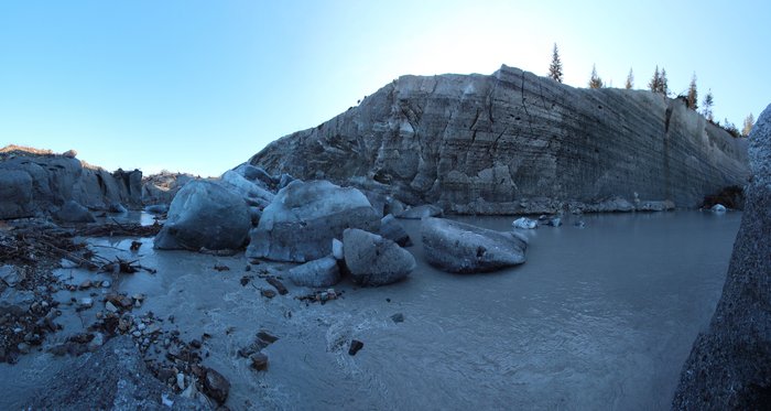 This forested ice face looks north, so it retreats by calving and passive heating from the air, not by solar heating.
