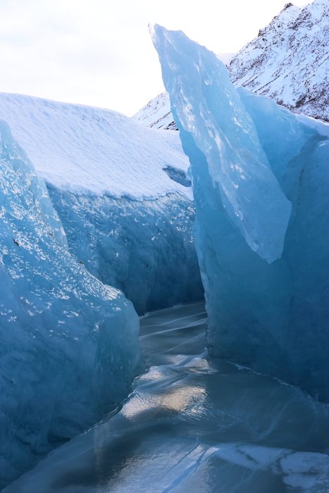 This crevasse on Grewingk Glacier is mostly filled with water that is now frozen. Ongoing motion of the glacier has deformed the ice.