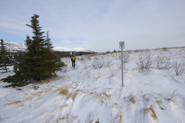 Kate passes by an old landfill site near Big Mountain. This was the site of a White Alice installation.