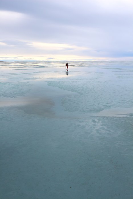 A thin sheen of water on ice sped up our skis, and reflected the sky above us