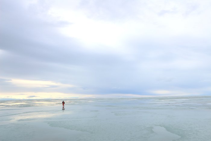 A thin sheen of water on ice sped up our skis, and reflected the sky above us