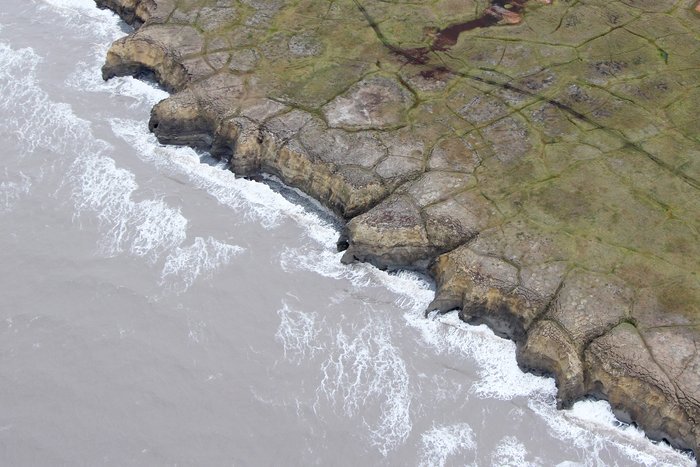 Just south of Barrow, these vertical bedrock cliffs are composed of soft material that is rapidly eroding into the ocean.