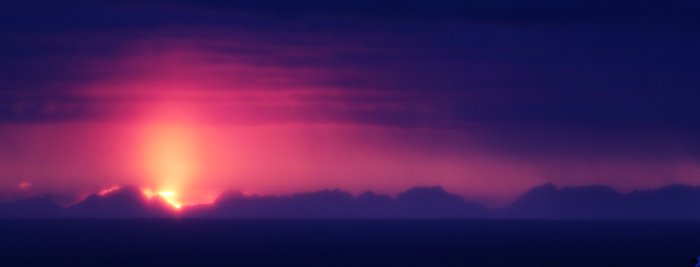 A blur of thin snow softens this primeval sunset.