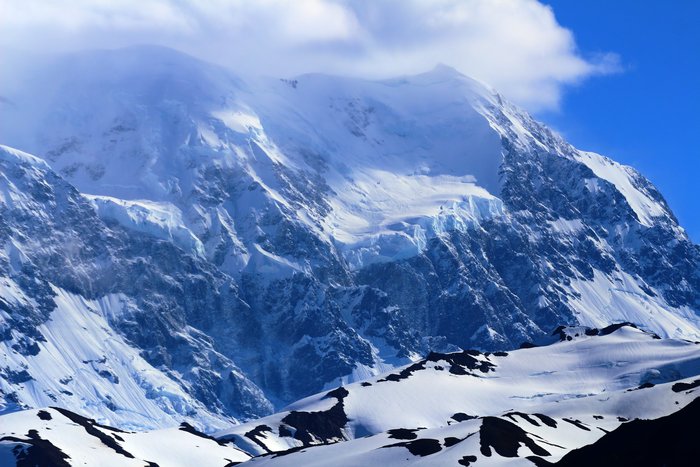 Looking through clouds at the harsh face of Mt. St. Elias.