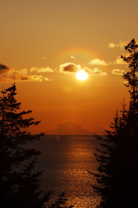 The sun sails past Augustine before falling into the ocean.