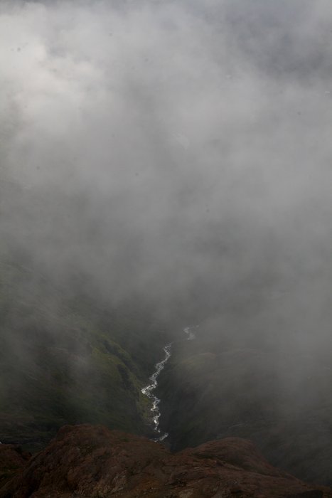 A river descends through mist to Taylor Bay.