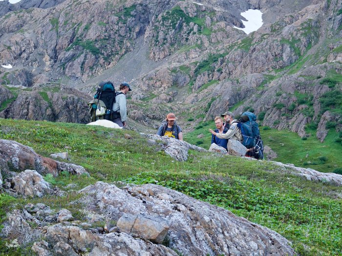 Discussing the trail route through a tundra bowl