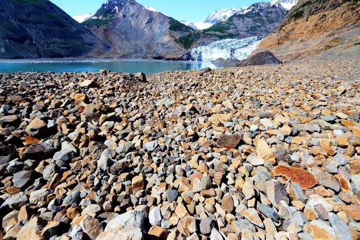 This sheet of small boulders is the upper layer of an approximately 2 meter thick tsunami deposit, left by a tsunami that reached 190 meters up the mountainside.