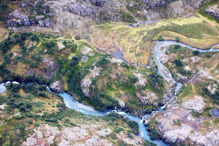 Complex mixed rock, trees, and tundra just beyond the end of the current trail.