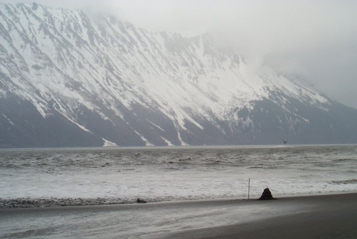 Photo 1 - A non-breaking but fast moving bore moves up the beach toward a stick and a pile of sand.