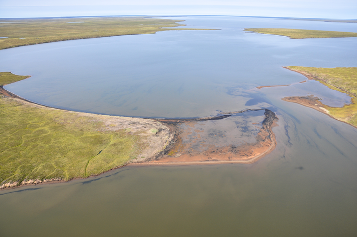 An arctic bay, with streaks of coal eroded from the bedrock.