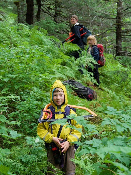 Katmai carries a bow saw up the mountain to help cut a trail.